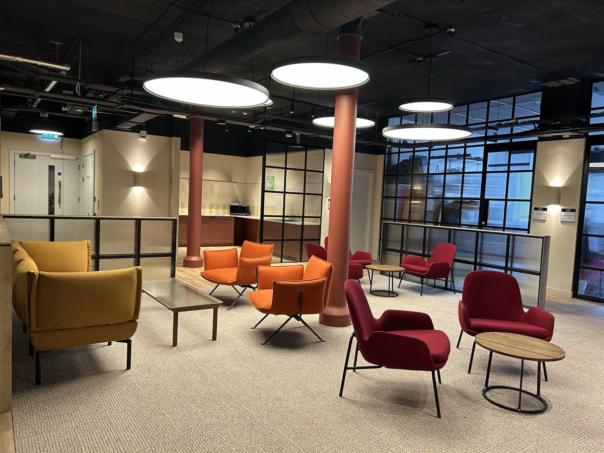 Cozy lounge area with colorful armchairs and coffee tables